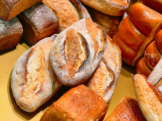 Artisan bread loaves displayed enticingly in a local bakery, showcasing various textures and crusts...