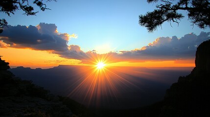 Naklejka premium Grand canyon sunset with vibrant colors and sun rays.