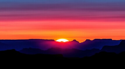 Fototapeta premium Vibrant sunrise over a mountain range.