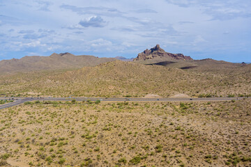 Highway stretches across arid Sonoran desert terrain in Maricopa County, Arizona scattered desert...