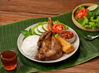 Bebek Goreng. Fried Duck Rice is duck meat that is fried and served with fresh vegetables plus a picnic