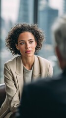 Professional woman engaged in conversation in a modern setting.