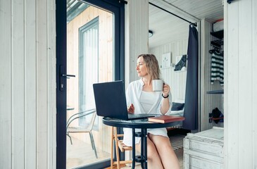 Creating a Calm and Focused Home Office Environment, a woman with a laptop at a table