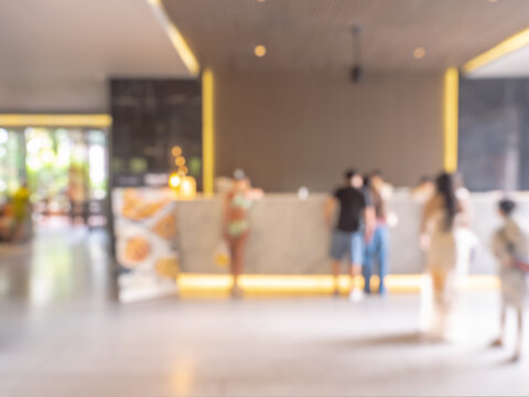 Abstract blurred hotel reception area at luxury interior background with people, business and travel on summer holiday vacation concept. Bright blur check in counter at hotel front desk, lobby zone.