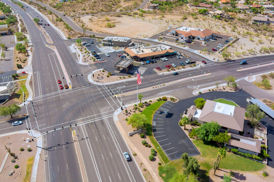 Complex multi lane roadways intersection with commercial buildings, parking lots, landscaped areas in Fountain Hills, Maricopa County, Arizona