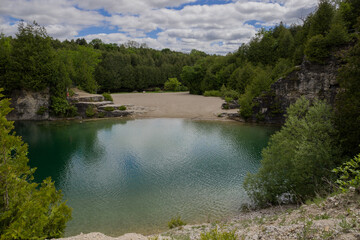 Elora quarry - the place with forest, rocks and amazing blue clear water. Popular place for activity - swimming, hiking and fishing on river. sunny summer day without people. Elora, Ontario, Canada