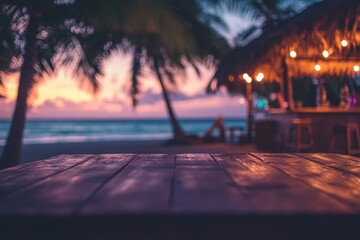 Wooden table on a beach at sunset with a beach bar in the background.