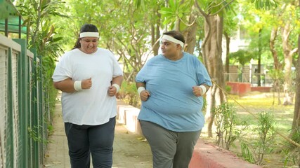 Obesity- Indian couple jogging together outdoor to lose weight. Plus size friends running at summer park Fat man and woman fitness workout and healthy lifestyle - Powered by Adobe