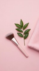 Powder Brush with Green Leaves and Pink Towel on Pastel Background