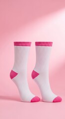 White and Pink Athletic Socks Standing on Vibrant Pink Background in Bright Studio