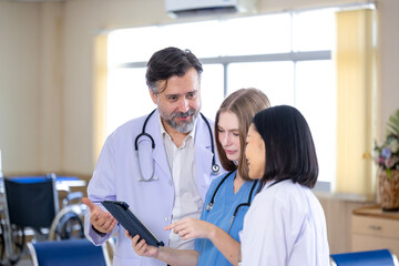 Team of diversity doctor and nurse is discussing and brainstorming over patient medical record...