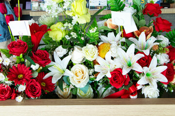 Creative layout made of flowers plastic multi-colored and leaves on blurred background. Flat lay....