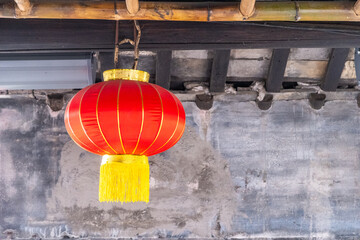 Red chinese lantern hanging from the roof. Oriental temple decoration