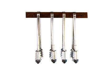 Aluminum food tongs or ice Hanging from small wooden beam to keep things organized in kitchen isolated on cutout PNG or transparent background. Cooking utensils kitchen necessities.