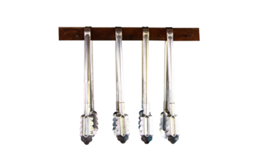 Aluminum food tongs or ice Hanging from small wooden beam to keep things organized in kitchen isolated on cutout PNG or transparent background. Cooking utensils kitchen necessities.