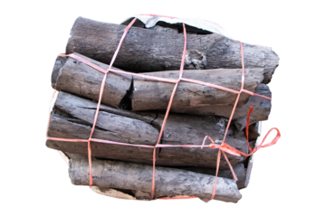 Charcoal dark black in white plastic bag tied with straw rope to make net for sale. Energy that humans made from tree. isolated on cutout PNG or transparent background.