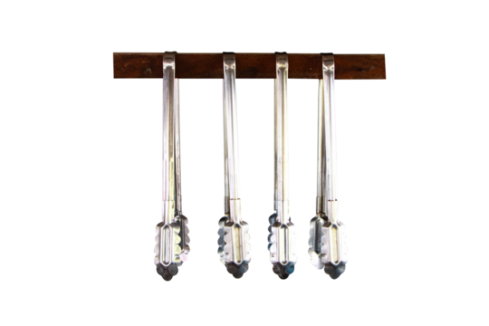 Aluminum food tongs or ice Hanging from small wooden beam to keep things organized in kitchen isolated on cutout PNG or transparent background. Cooking utensils kitchen necessities.