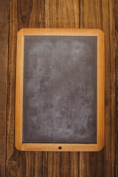 Fototapeta Flat design vector illustration is showing wood-framed chalkboard on rustic wooden plank background