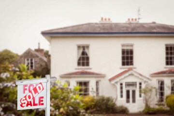 Real estate signboard in front of house exterior