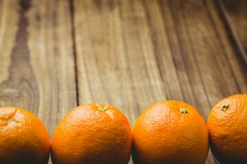 Close-up of oranges on wooden table