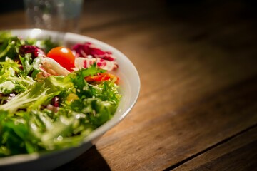 Healthy bowl of salad on wooden table