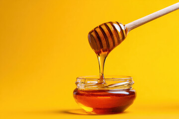 Golden honey pour on yellow background