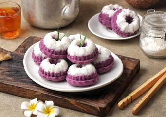 Putu Ayu Ubi Ungu Cake is a cake with mashed boiled purple sweet potatoes sprinkled with delicious grated coconut, Putu Ayu Cake on a wooden plate, Traditional Indonesian cake