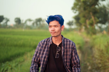 Man with Blue Hair in a Rice Paddy Field
