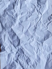 Wrinkled Texture: An abstract overhead shot of a crumpled piece of paper, showcasing its intricate folds and textures.