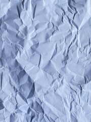 Wrinkled Paper Texture: Close-up shot of crumpled paper, highlighting texture, shadows, and folds, conveying concept of waste, process or creativity.