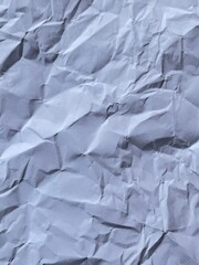 Crinkled Paper Texture: A detailed close-up of a crumpled piece of paper, showcasing a complex pattern of folds, shadows, and textures, evoking feelings of chaos and disarray.