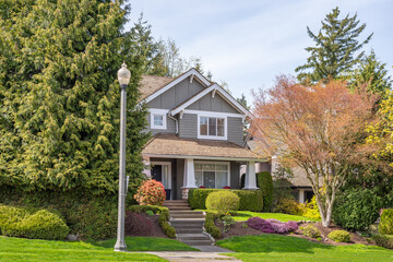 Two story stucco luxury house with nice spring blossom landscape in Vancouver, Canada, North America. Day time on June 2025.
