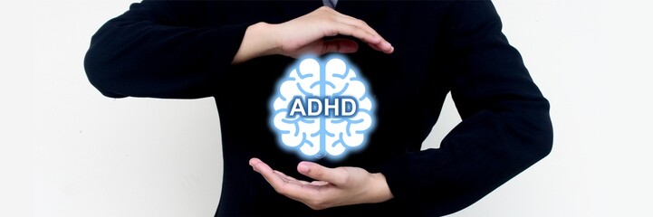 ADHD psychology concept presentation with glowing brain symbol held by person in black suit. Ideal...