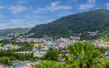 Obraz premium view of Patong and Patong Beach from the mountains colourful skies at Sunset. Patong is a vibrant city full of tourists from all around the world. 