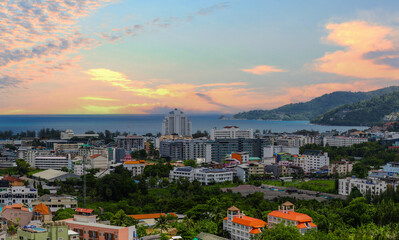 view of Patong and Patong Beach from the mountains colourful skies at Sunset. Patong is a vibrant...