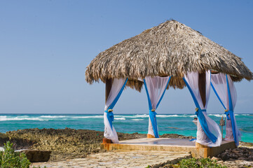 Gazebo by the sea, surrounded by beautiful turquoise waters, decorated for a wedding ceremony