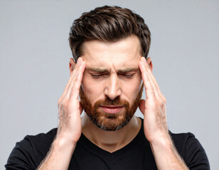 Bearded Man in Pain Holding Head with Eyes Closed – Migraine or Stress Concept
