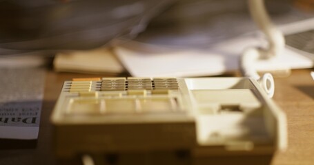 A man dials a phone number, close-up of his hand, an unrecognizable person. Analog phone on the...