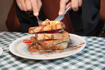 Delicious stack of French toast with toppings being served