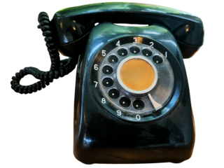 A classic black rotary dial telephone with a coiled cord, showcasing a vintage design and circular number dial.