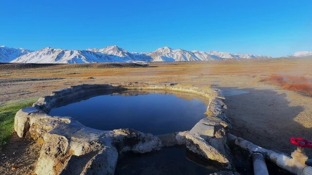 Winter early morning blue sky natural hot springs hot tub soak sunny sky snow covered Mammoth Mountain Minarets aerial drone Convict Canyon Hilltop Whitmore Wild Willys Hot Springs peaceful steam