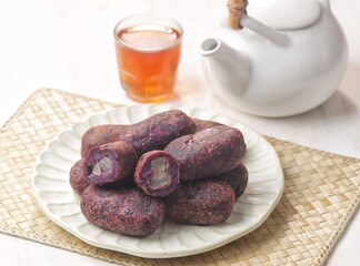 Timus Ubi Ungu. Purple sweet potato thymus filled with candied bligo. Many are used as typical Karanganyar souvenirs