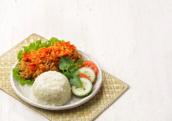 Ayam geprek is a typical Indonesian fried chicken dish with flour that is mashed or mashed with plow chili sauce