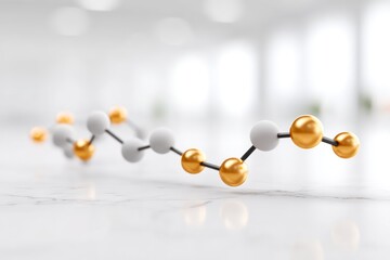 Abstract molecular structure with white and gold spheres connected by black rods on a bright blurred background