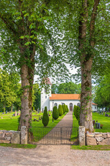 Church with a gate and gravel path in the cemetery