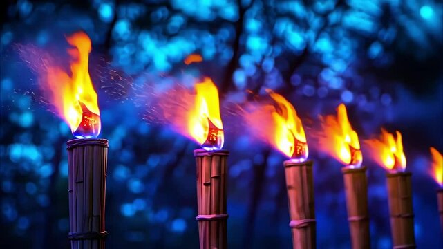 A row of lit torches with vibrant flames against a blurred blue background, creating a dramatic and festive atmosphere.