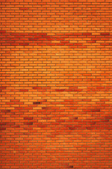 Vertical shot of orange clay brick wall pattern on a residential building facade
