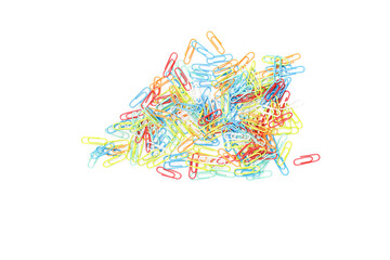 Colorful paper clips scattered on a white background creating a vibrant and playful stationery...