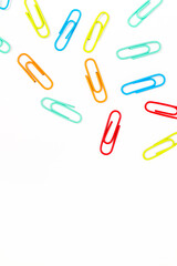 Vibrant Array of Colorful Paper Clips Scattered on a Clean White Background