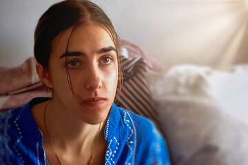 Young woman in pajamas lying in bed